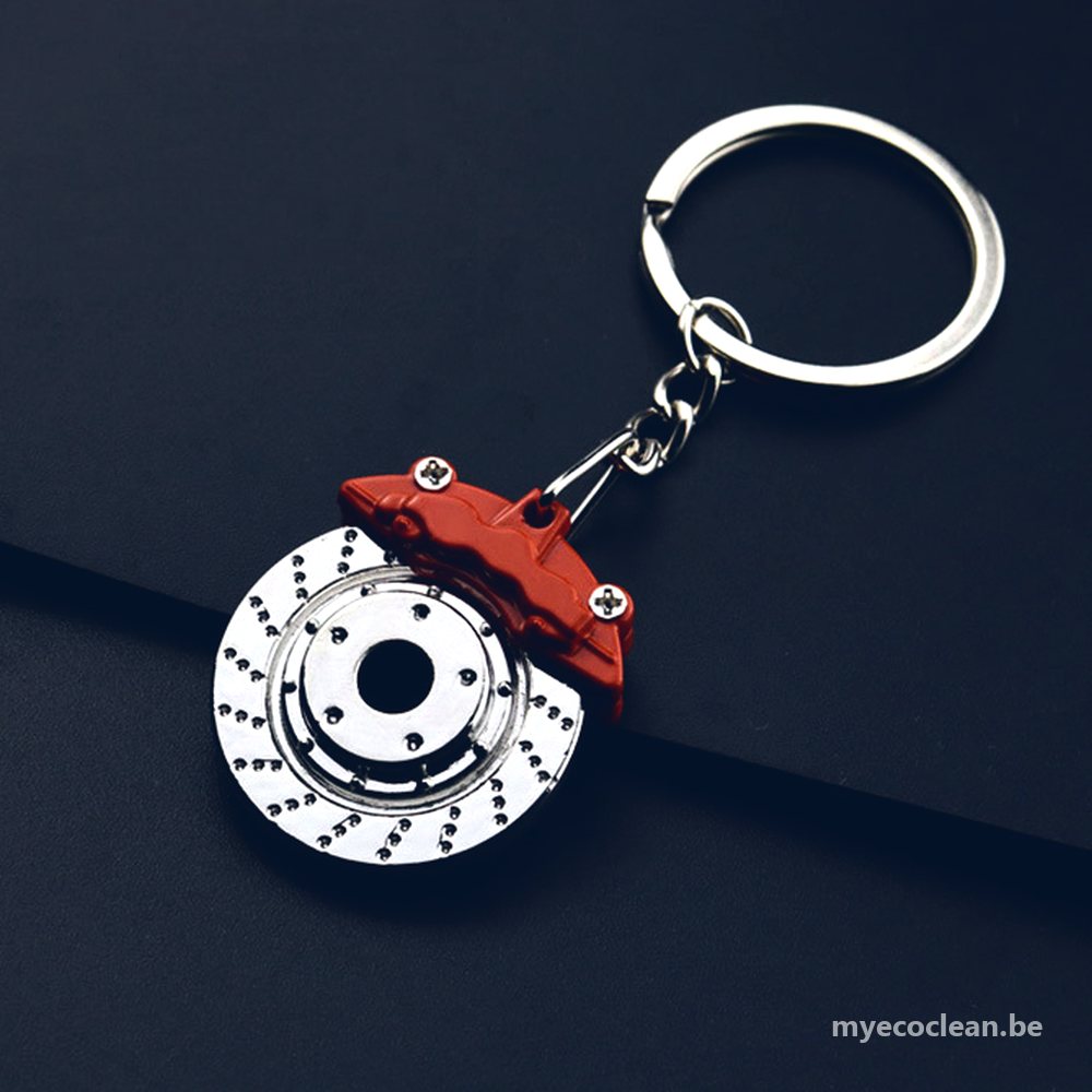 Porte-clés disque de frein en métal chromé avec étrier rouge, sur fond bleu nuit